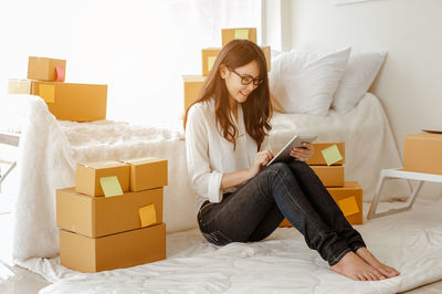 Young woman using mobile phone at home