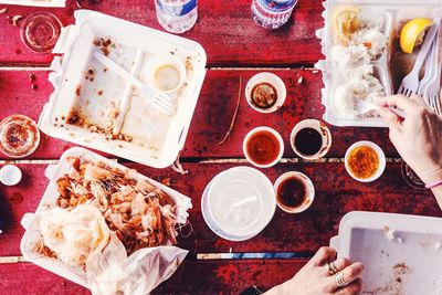 High angle view of hand holding food on table