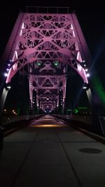 Illuminated tunnel at night