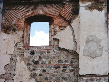 Close-up of brick wall against sky