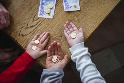 Hands holding coins