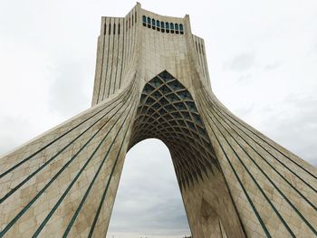 Low angle view of bridge against cloudy sky