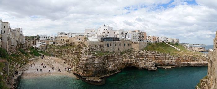 Panoramic view of sea and buildings against sky