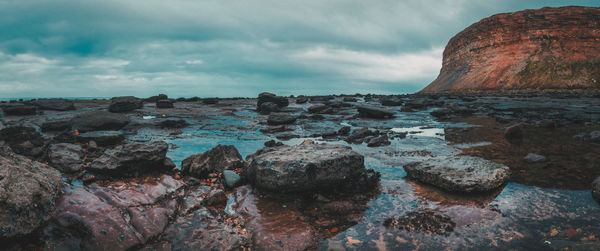 Scenic view of sea against cloudy sky