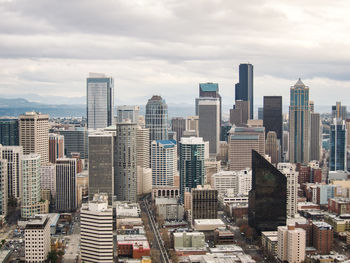 Cityscape against cloudy sky