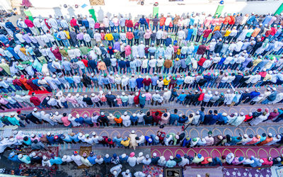 High angle view of crowd praying on road