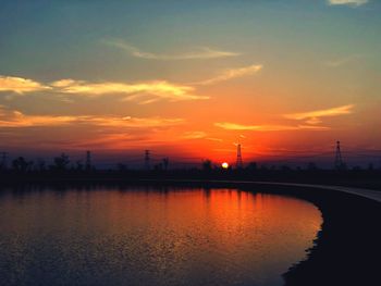 Scenic view of lake against orange sky