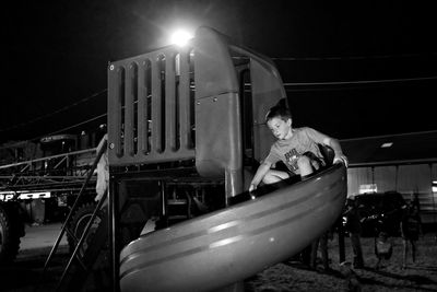 Boy on slide at gage county fair during night