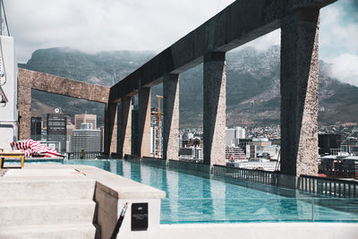 View of swimming pool against cloudy sky