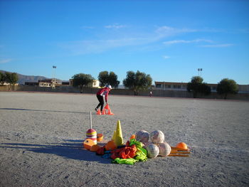 Rear view of man with stuffed toy against sky