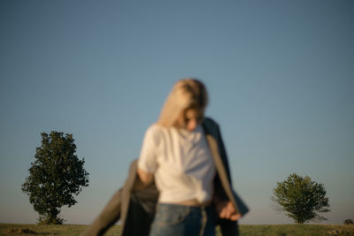 Woman standing against clear sky