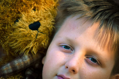 Close-up portrait of boy with toy