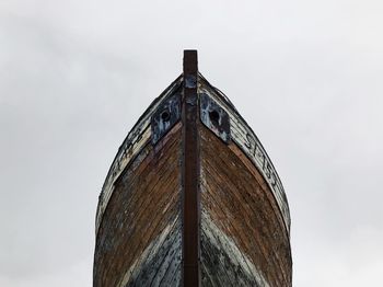 Low angle view of rusty structure against sky