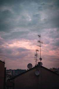 Low angle view of telephone pole against sky during sunset