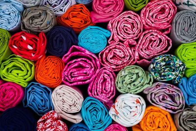 Close up view on samples of cloth and fabrics in different colors found at a fabrics market.