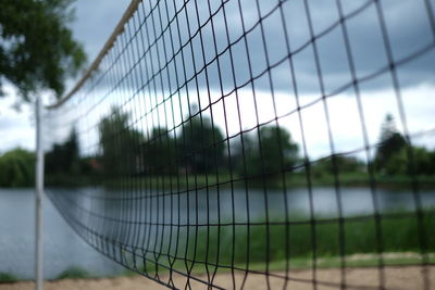 Volleyball net against lake