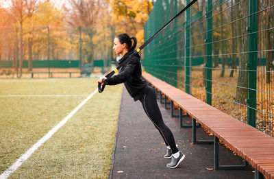 Full length side view of woman exercising