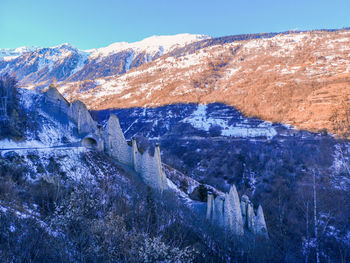 Scenic view of snowcapped mountains against blue sky