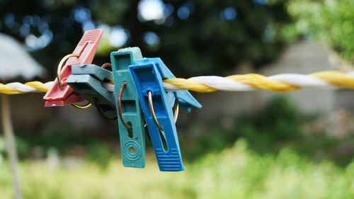 Close-up of clothespins hanging on clothesline