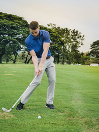 Full length of young man playing golf