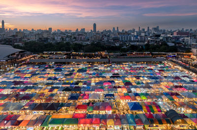 Aerial view of cityscape against sky during sunset