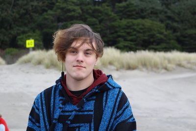 Portrait of young man standing on land