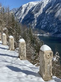 Scenic view of snow covered field against mountain in hallstatt austria 