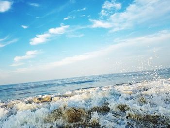 Scenic view of beach against blue sky