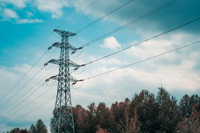 Low angle view of electricity pylon against sky