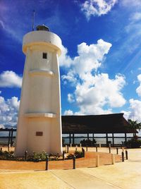 Lighthouse against cloudy sky