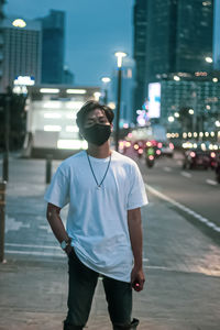 Man standing on street in city