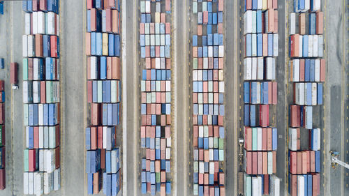 Directly above shot of stacked containers at harbor