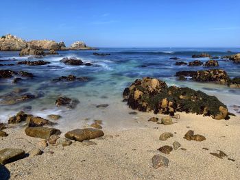 Beautiful ocean landscape along pacific groves rocky scenic coastline with crashing waves and blue s