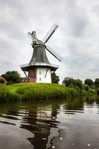 Traditional windmill against sky