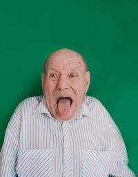 Portrait of man wearing mask against gray background