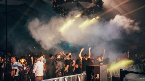 People enjoying music concert at night