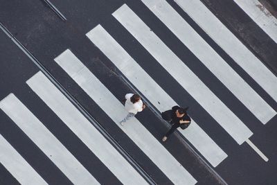 High angle view of people crossing road