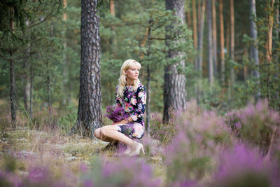 Beautiful woman looking away while sitting at lavender field