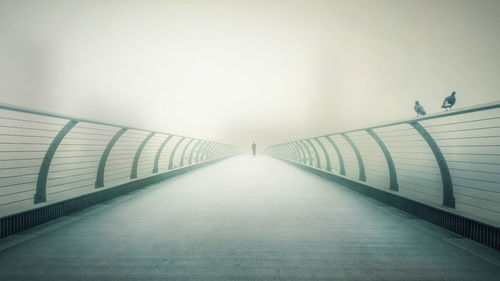 Footbridge against clear sky