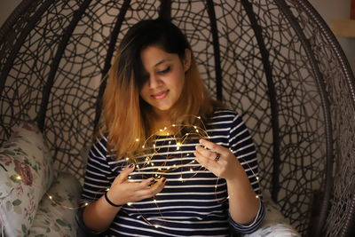 Young woman looking away while using mobile phone