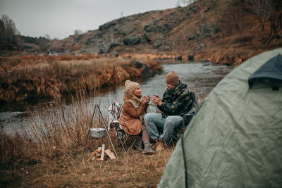 Couple in love in autumn on a camping near the river