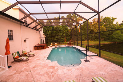 Swimming pool by building against clear sky