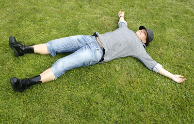 High angle view of woman lying on field on field