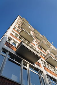 Low angle view of building against clear blue sky