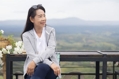 Full length of woman sitting on bench