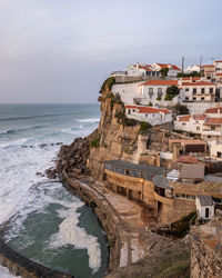 Scenic view of sea and buildings against sky