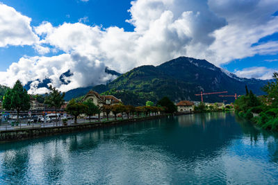 Scenic view of lake by buildings against sky