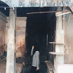 Woman standing in corridor of building