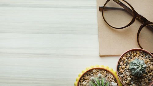 Directly above potted plants and eyeglasses on table