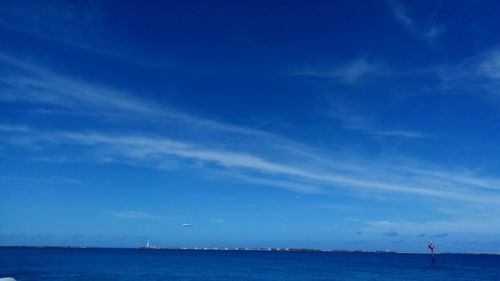 Scenic view of sea against blue sky